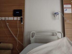 A patient's view from a hospital ward bed after transfer from the ICU following kidney transplant surgery.